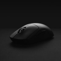 black cordless computer mouse on black surface