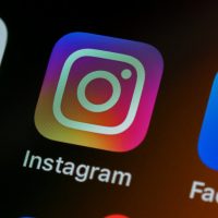 The Instagram app icon on a smartphone screen with other app icons
