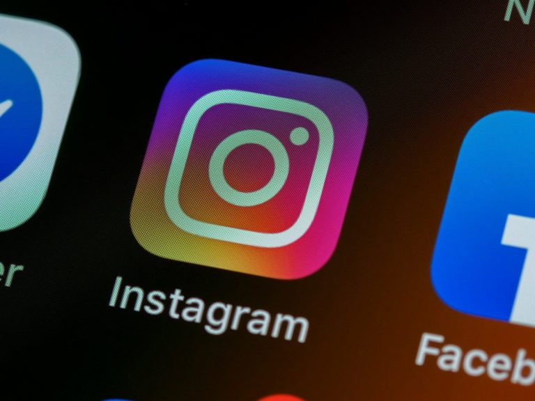 The Instagram app icon on a smartphone screen with other app icons