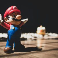 Super Mario figurine on brown surface