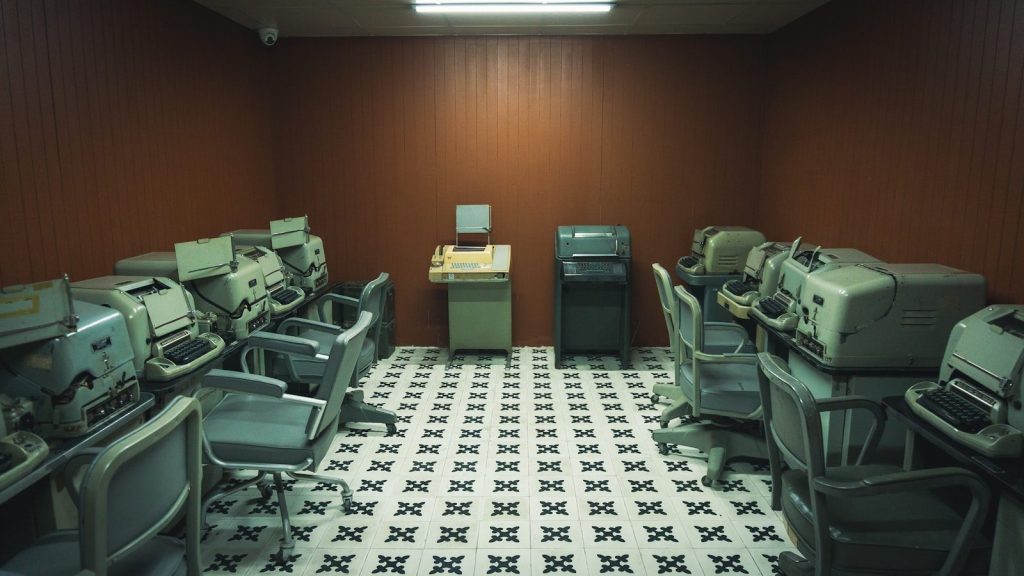 a room filled with lots of computers and desks
