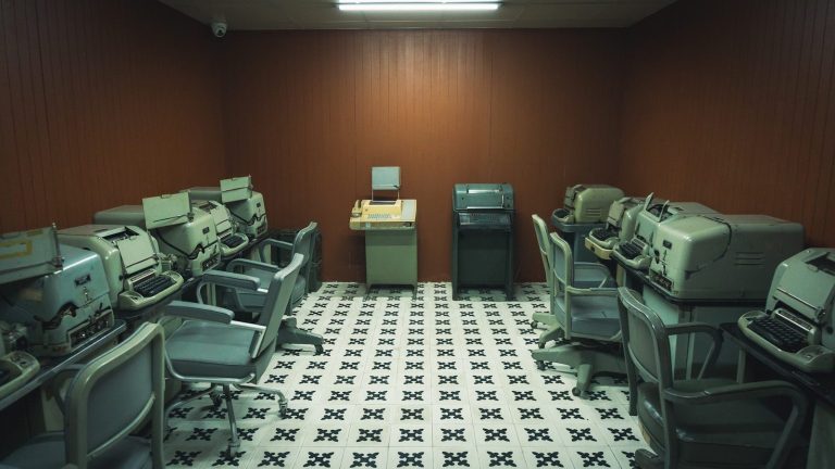 a room filled with lots of computers and desks