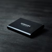 black power bank on black wooden table